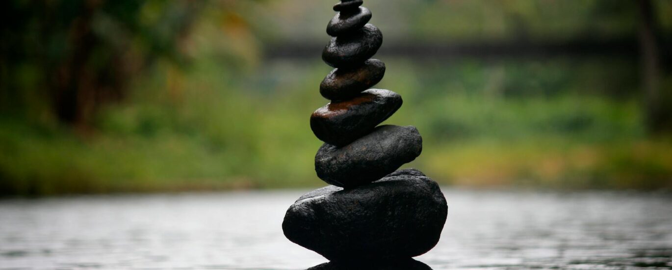 black stackable stone decor at the body of water