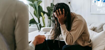 stressed black man with dreadlocks in psychological office