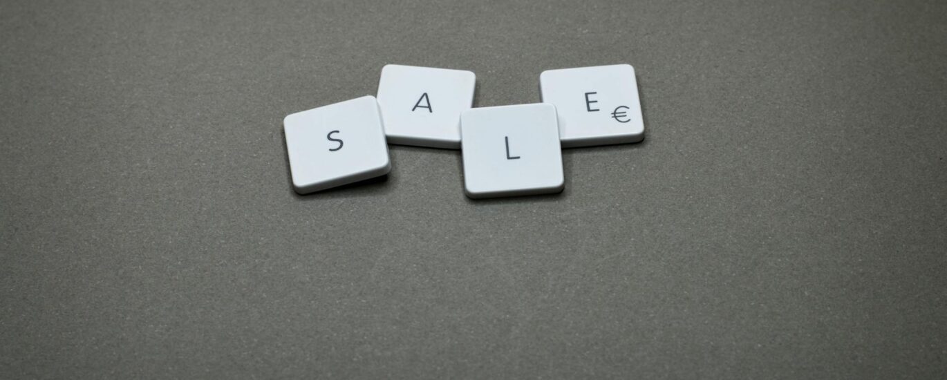 four white sale boards