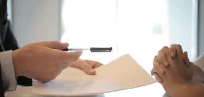crop businessman giving contract to woman to sign