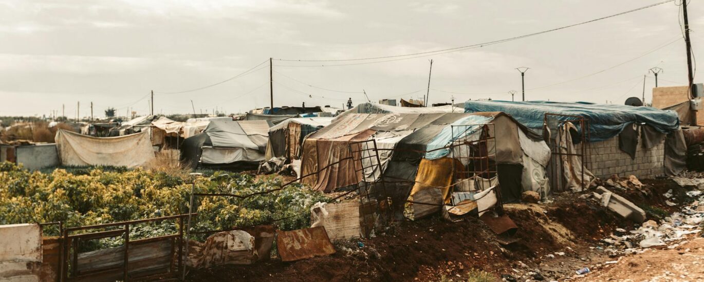 temporary shelters in refugee camp landscape