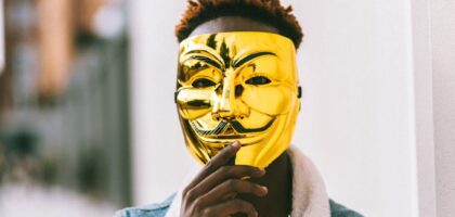 black man covering face with anonymous mask