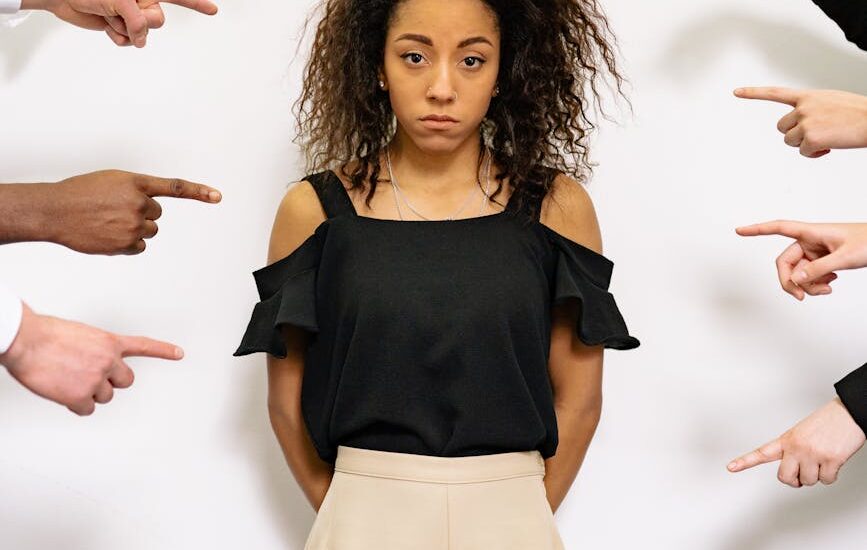 people pointing fingers at a stressed woman